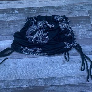 Black with white dragon design, fitted mini skirt, size small